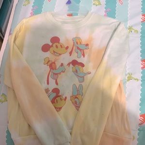 Some details are Mickey Mouse cast and it is a tie dye sweater